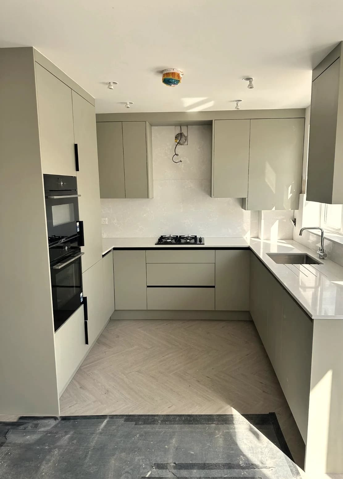 Sage Green Modern Kitchen with Integrated Appliances